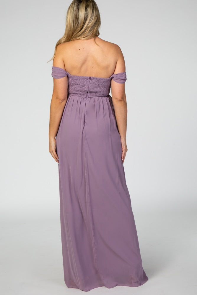 woman wearing a lavender off-the-shoulder maternity maxi dress, showing the back view and a fitted smocked bodice