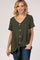 woman wearing an olive green short sleeve button down top with a front tie hem and blue jeans