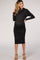 woman wearing a black cowl neck midi maternity dress that shows off her baby bump