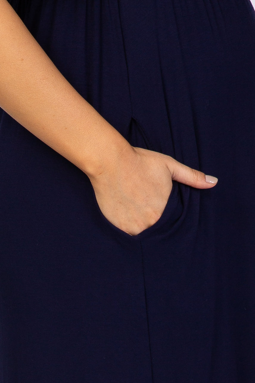 close up of a hand in the side pocket of a navy blue dress