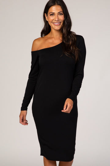 woman wearing a black off-the-shoulder long sleeve dress with a fitted silhouette