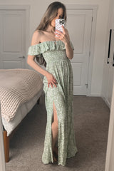 woman wearing a green floral off-the-shoulder maxi dress with a ruched bodice and thigh-high slit