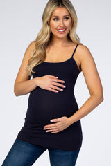 woman wearing a dark navy maternity tank top and holding her baby bump