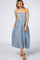 woman wearing a blue striped sleeveless maxi dress with buttons down the front and a relaxed fit