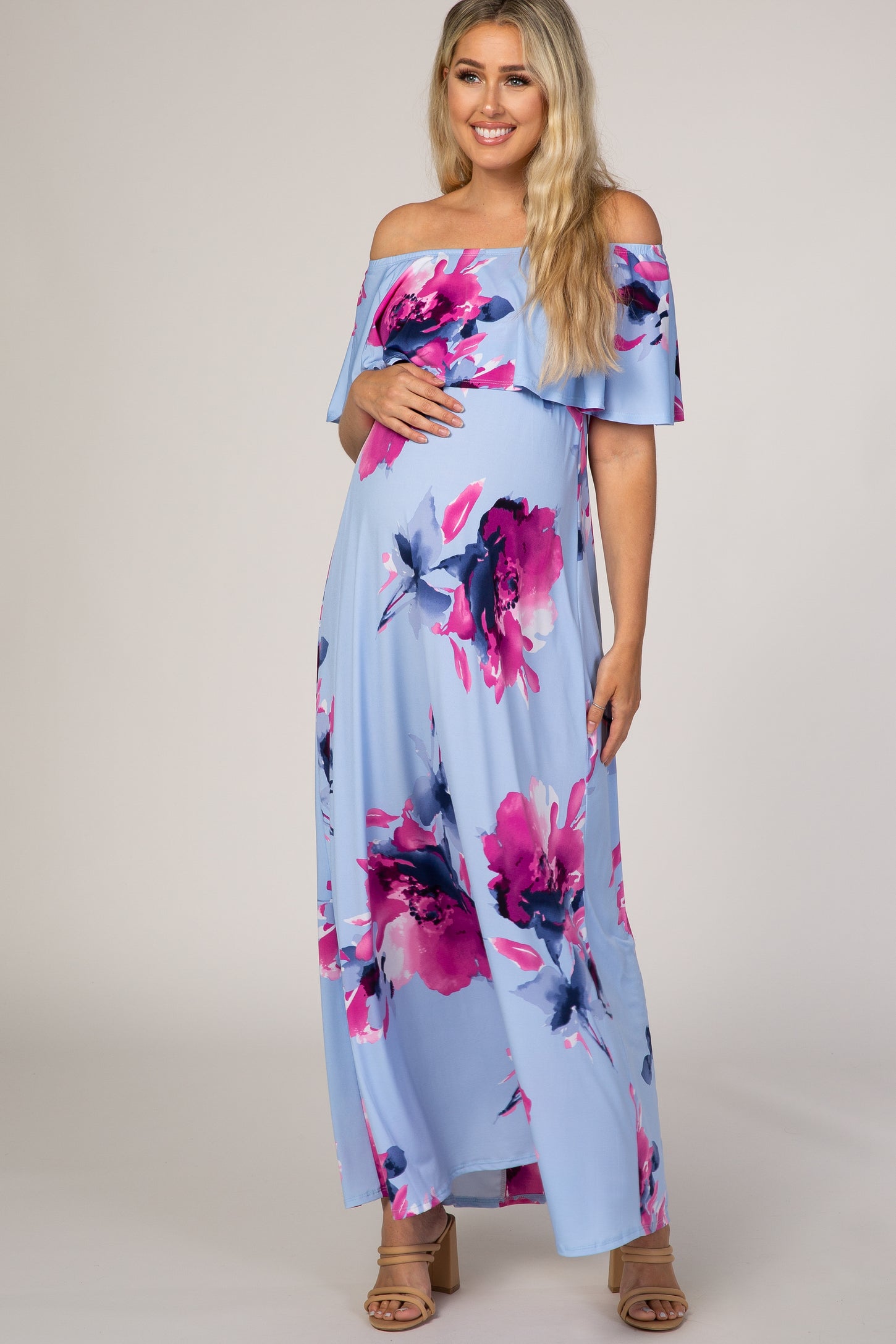 pregnant woman in light blue off the shoulder floral maternity maxi dress with pink and purple flowers