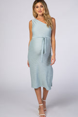 pregnant woman wearing a light blue ribbed one-shoulder maternity midi dress with a waist tie
