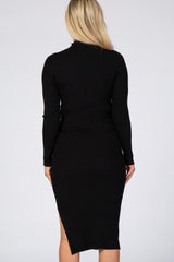 back view of a woman with blonde hair wearing a long sleeve black ribbed midi dress