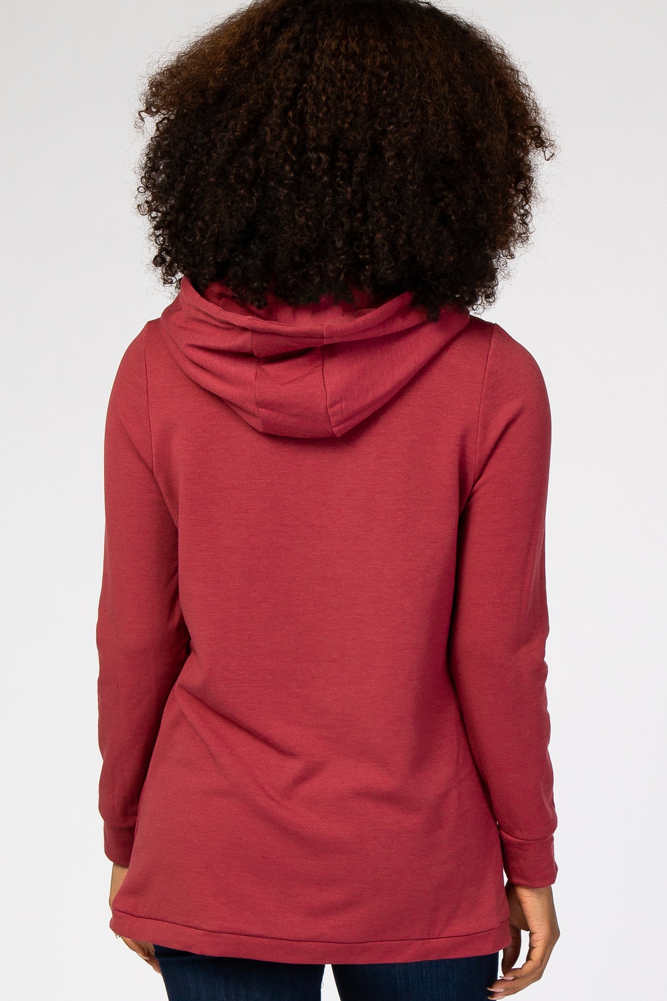 woman wearing a burgundy long sleeve hoodie with a relaxed fit and a hood, shown from the back