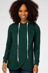 woman wearing a dark green long sleeve hoodie with a crossover front and white drawstrings