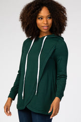 woman wearing a dark green hoodie with white drawstrings and a stylish crossover front detail