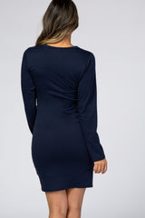 back view of a woman wearing a navy blue long sleeve bodycon mini dress