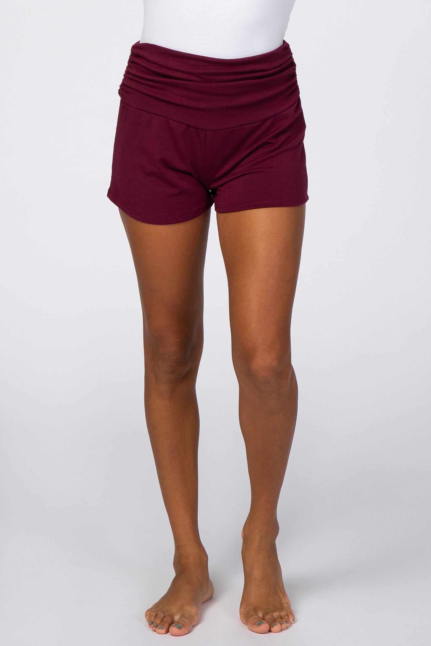 woman wearing burgundy lounge shorts with a ruched waistband and a relaxed fit