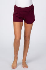woman wearing burgundy maternity shorts with ruching at the waist