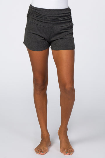 woman wearing dark gray high-waisted shorts with gathered waistband