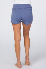 woman wearing blue maternity shorts, showing a comfortable design with a fold-over waistband from the back