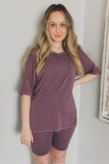 woman wearing a mauve oversized t-shirt with a pocket and matching bike shorts