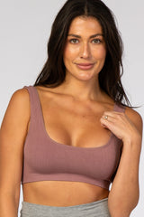 woman wearing a mauve ribbed scoop neck sports bra and grey leggings
