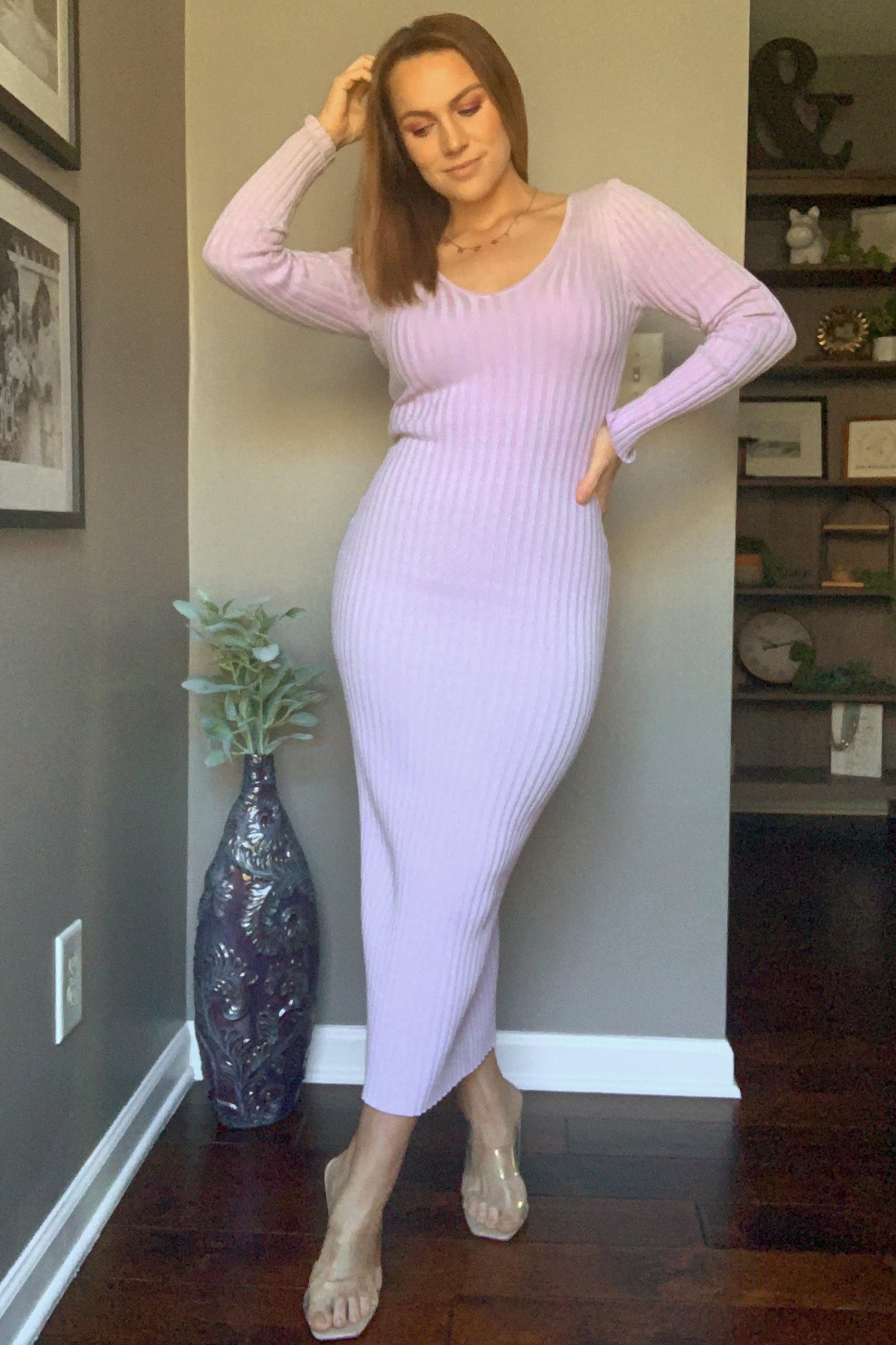 woman wearing a light purple ribbed long sleeve midi dress with a scoop neckline and a side slit