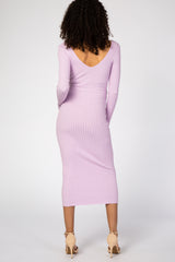 woman wearing a lilac long sleeve ribbed maternity dress with a v-back and fitted silhouette