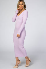 woman wearing a light purple ribbed maxi dress with long sleeves and a deep v-neck, styled with nude heels