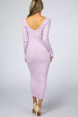 woman wearing a lilac long sleeve ribbed midi dress with a deep v-back and fitted silhouette