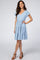 woman wearing a light blue short sleeve tiered maternity dress with brown block heel sandals