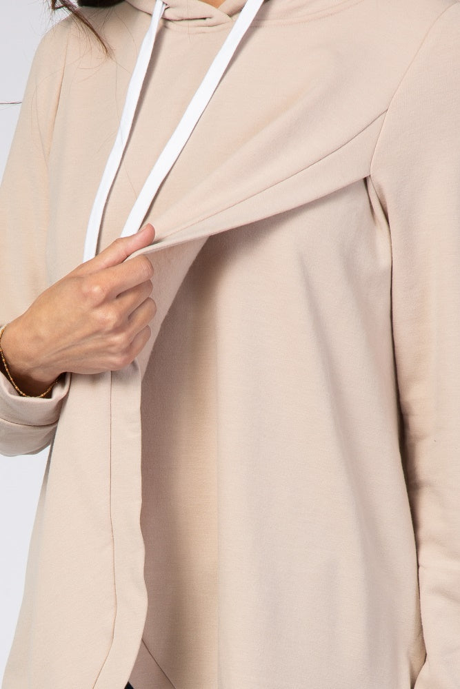 Close up of a beige maternity nursing hoodie with a hidden flap for breastfeeding access