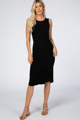 blonde woman wearing a sleeveless black ribbed midi dress and tan block heel sandals
