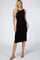blonde woman wearing a sleeveless black ribbed midi dress and tan block heel sandals