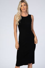 blonde woman wearing a sleeveless black ribbed midi dress against a white background
