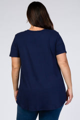 back view of a woman wearing a navy blue short sleeve t-shirt and blue jeans