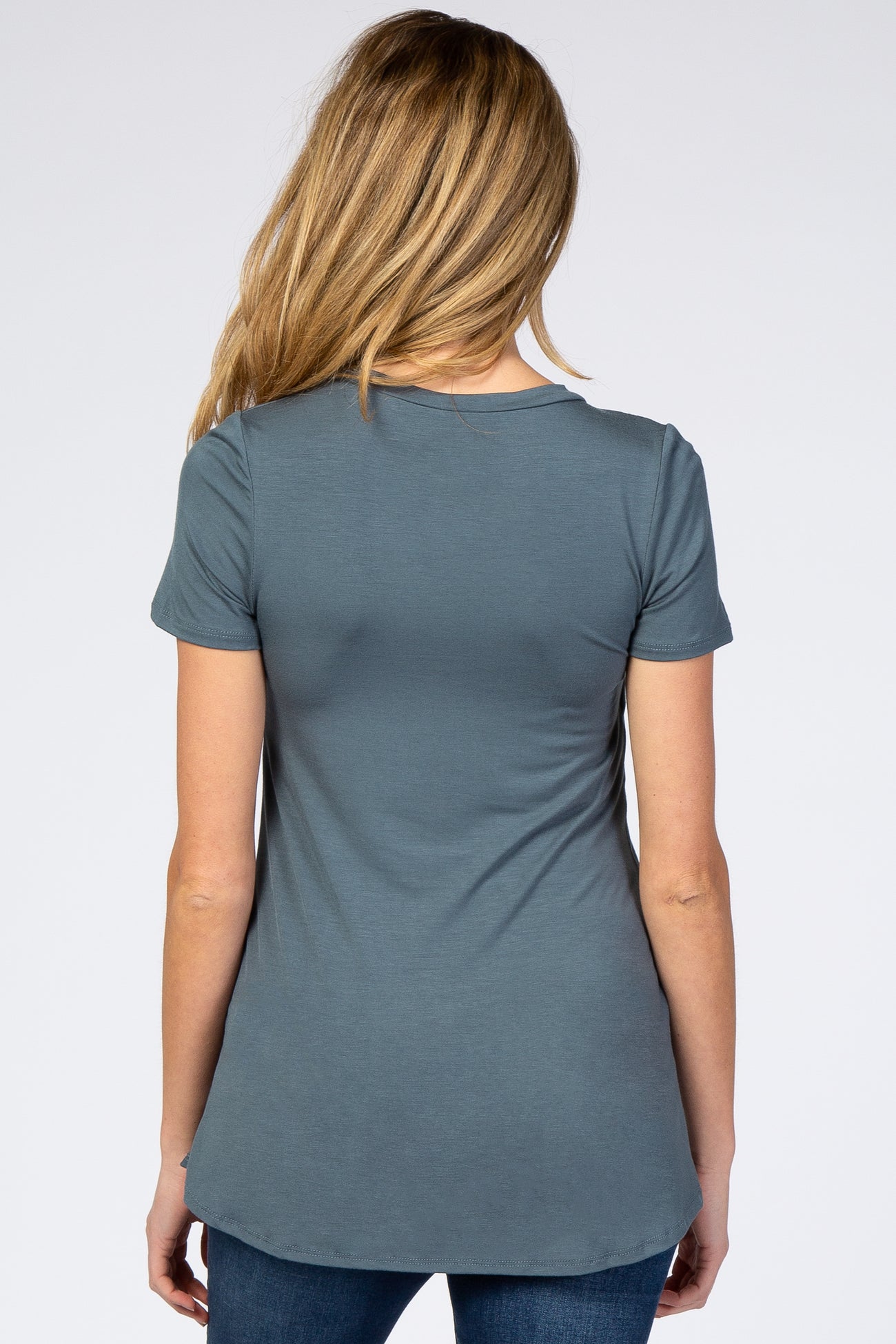 woman wearing a teal short sleeve maternity top, viewed from the back, featuring a relaxed fit and curved hem