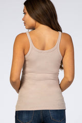 woman wearing a fitted beige maternity tank top, showing her back with a smooth ribbed texture