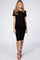 woman wearing a black short sleeve maternity dress, highlighting her baby bump