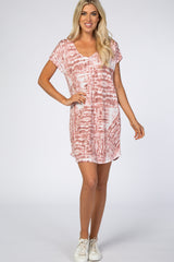 woman wearing a mauve and white tie dye short sleeve t-shirt dress with white sneakers