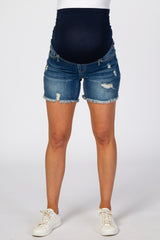 maternity wear distressed denim shorts with a navy belly panel and frayed hem, model wearing white sneakers