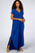 woman wearing a royal blue short sleeve maxi dress with side slits and a v-neckline