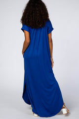 woman wearing a long blue maxi dress with short sleeves and side pockets, viewed from the back
