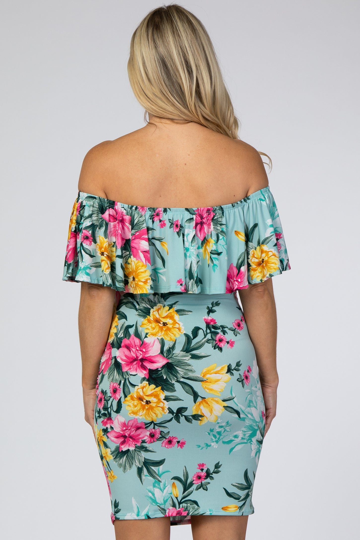 woman wearing a floral off-the-shoulder maternity dress with a fitted bodycon style