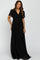 woman wearing a black maxi maternity dress with short sheer sleeves and a tied waist detail