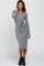 woman wearing a long sleeve grey ribbed midi dress with a waist tie and black ankle boots