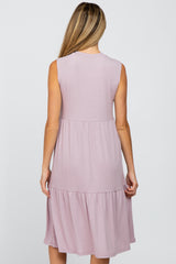 Back view of a woman wearing a mauve sleeveless tiered ribbed knit midi dress