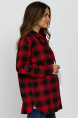 woman wearing a red and black checked maternity shirt and holding her baby bump