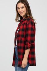 woman wearing a red and black plaid long sleeve shirt with rolled sleeves and blue jeans