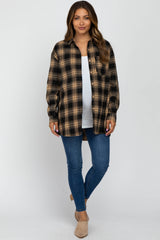 woman wearing a black and tan plaid maternity shirt over a white top and blue jeans, with long hair styled down