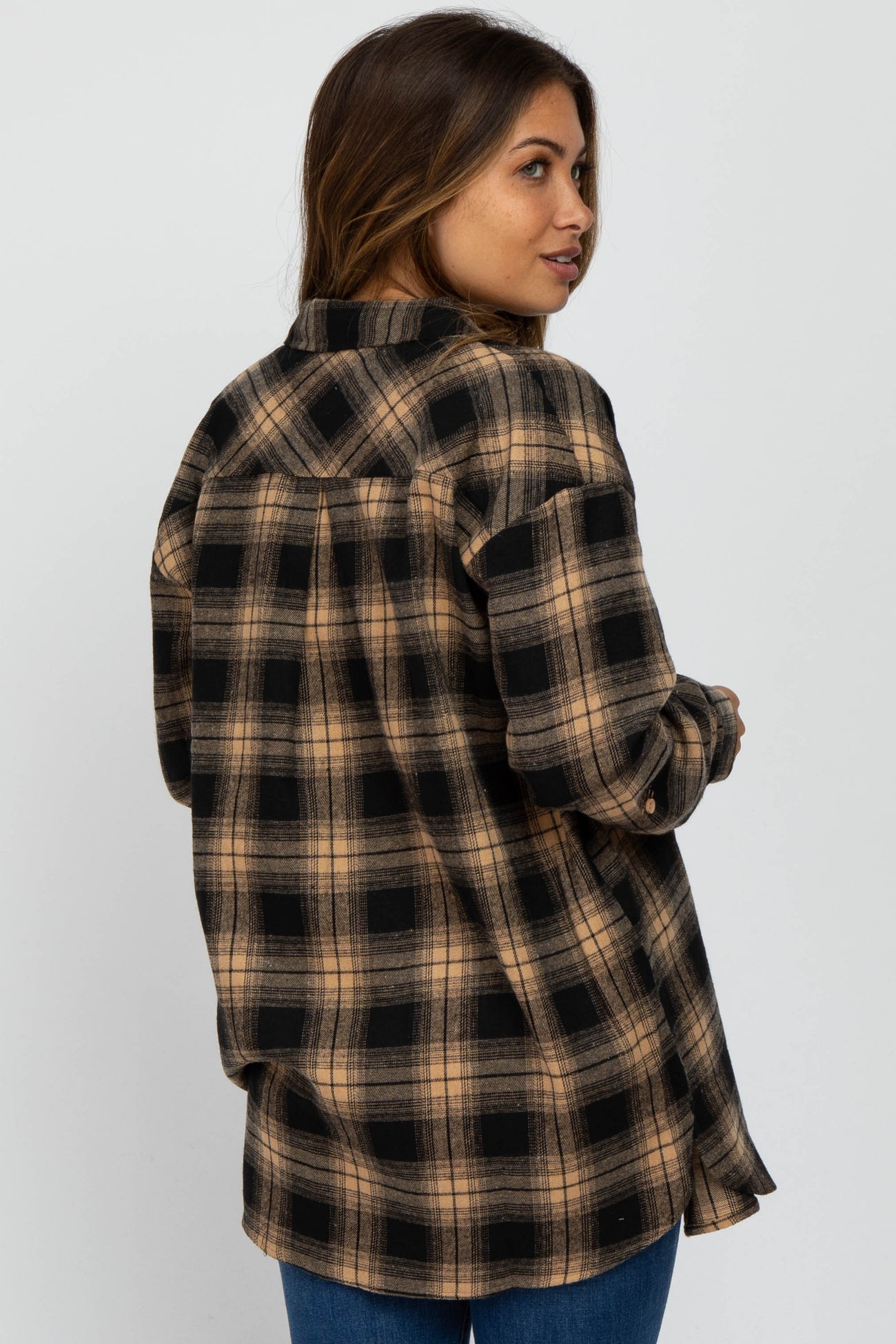 woman wearing a brown and black plaid maternity flannel shirt with a relaxed fit, showing the back view