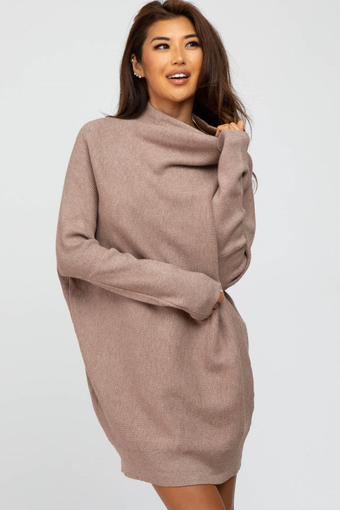 woman wearing a beige oversized cowl neck sweater dress with long sleeves and a relaxed fit