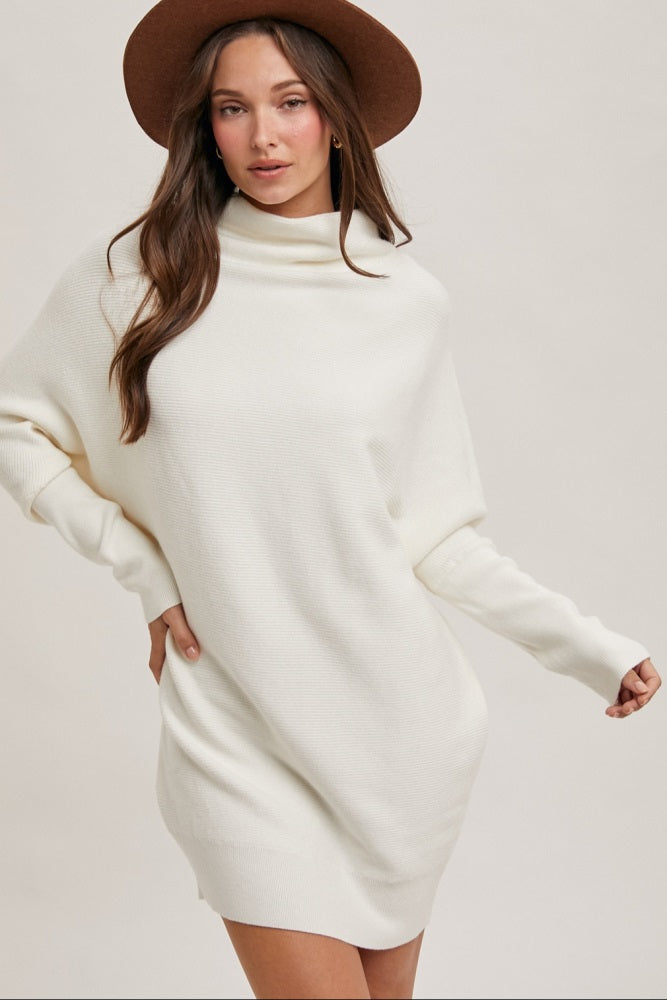 woman wearing a white turtleneck sweater dress and a brown wide-brimmed hat