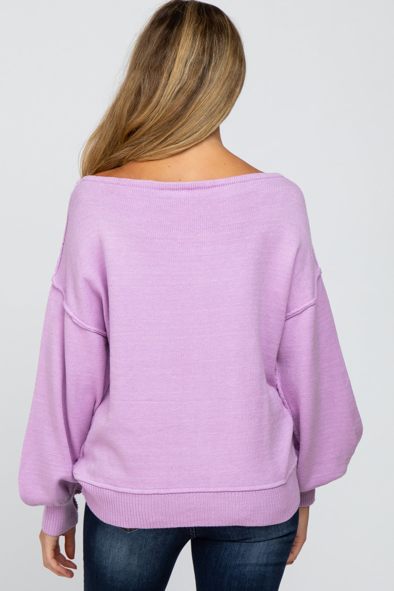 woman wearing a lilac oversized maternity sweater with a relaxed fit, seen from the back