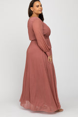 woman wearing a rose pink long sleeve maxi dress with a side view showing flowy silhouette and gathered waistline